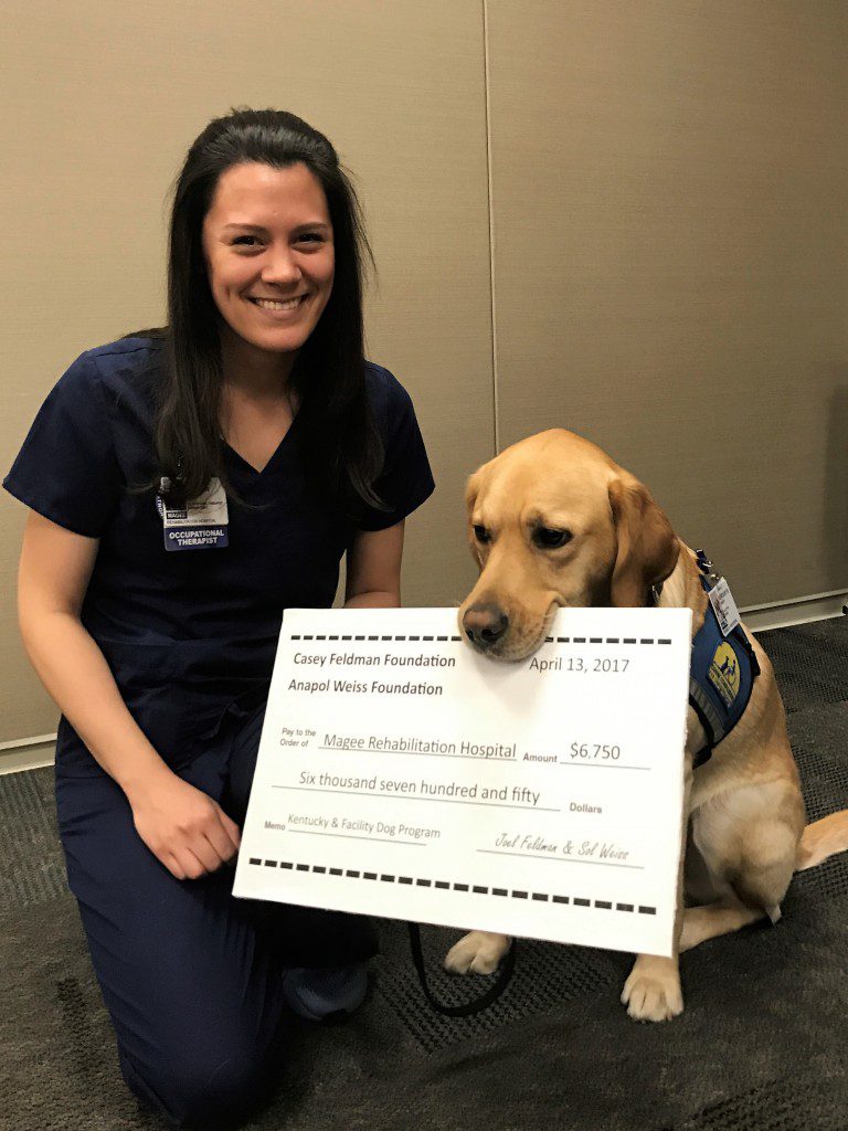 Therapist Kirsten Ondich with Kentucky and the Foundations' check